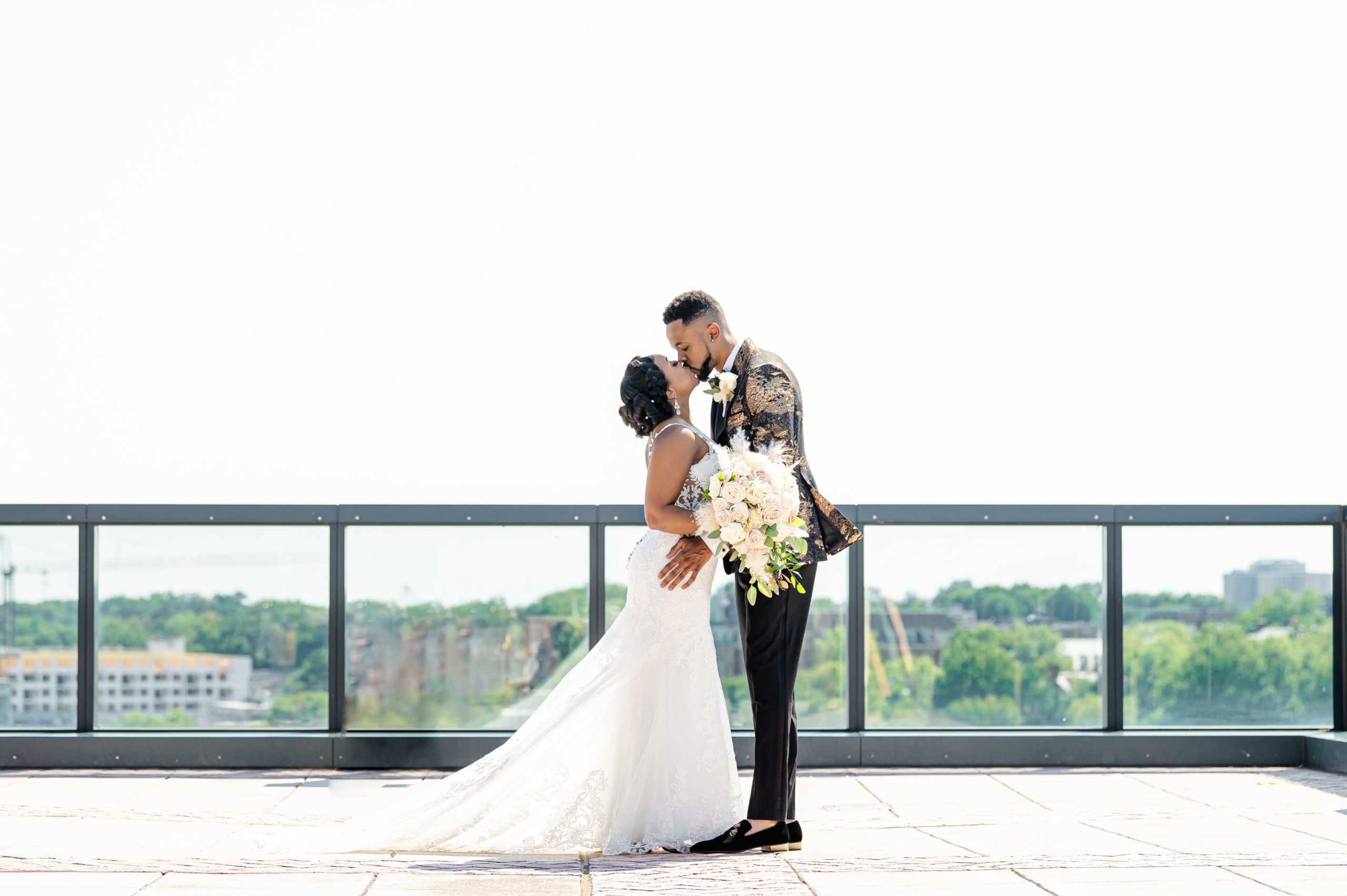 a bride and groom standing outside in their wedding attire